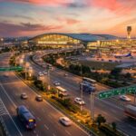Aerial view of the new Noida International Airport (Jewar Airport) at sunset, highlighting the massive infrastructure development driving real estate and property price surges in the NCR region.