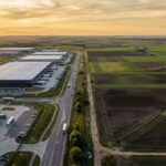 Aerial view of a modern logistics park highlighting the massive manufacturing push in integrated industrial townships.