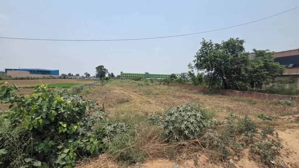 Agricultural land and plot in Baghpat property image showing surrounding agricultural corridor and nearby development