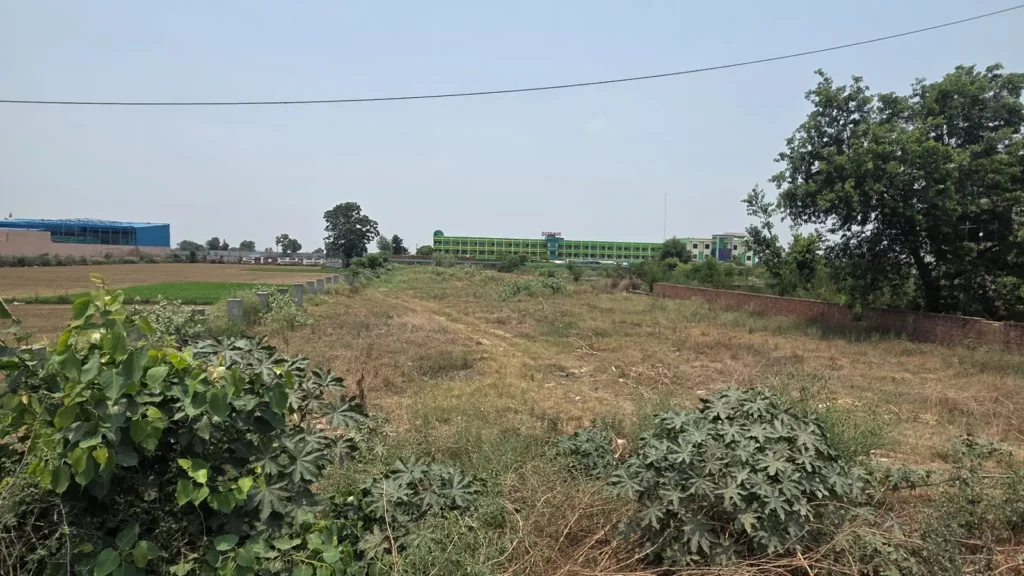 Agricultural land and plot in Baghpat property image showing open land parcel and surrounding agricultural environment