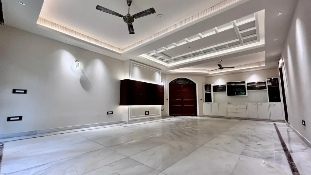Large main hall of Residential Kothi in Noida Sector 56 featuring luxury interiors and designer ceiling.